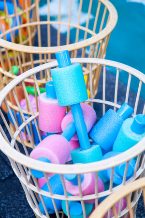 Water Aqua Aerobic Equipment. Colored aqua noodles in basketの写真素材