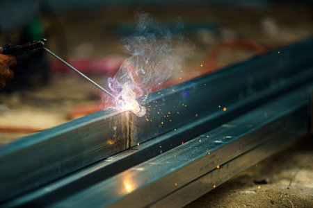 Close up the mechanic welding worker without safety in heavy industry. Dangerous and unsafety concept.の写真素材