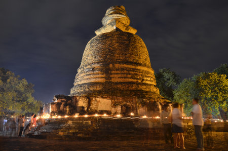 Pagoda and light of the candle in Thailandの写真素材