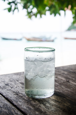 glass on table at the beachの写真素材