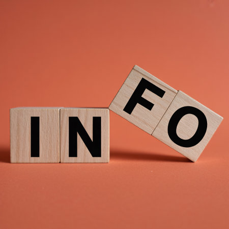Close-up shot of wooden alphabet blocks spelling out the word INFO on a plain orange background.の素材