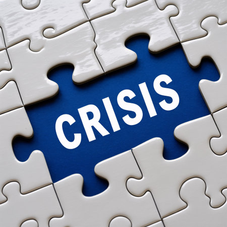 A close-up view of a puzzle with one blue piece in the center, prominently displaying the word CRISIS in white capital letters. The surrounding puzzle pieces are white and interconnected, creating a visual metaphor for problem-solving and finding solutions amidst challenges.の素材