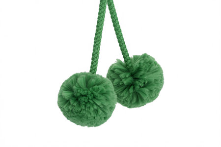 two green pom pom tassels on a white background, perfect for crafts, decorations, and embellishments.の素材