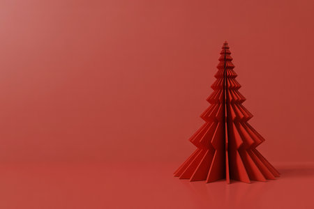 A minimalist and festive image featuring a single red origami Christmas tree standing on a matching solid red background, creating a monochromatic and elegant holiday scene.の素材