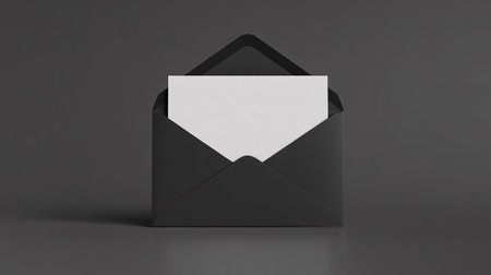 A stark, minimalist image of an open black envelope with a blank white card peeking out, set against a dark, reflective surface.の素材