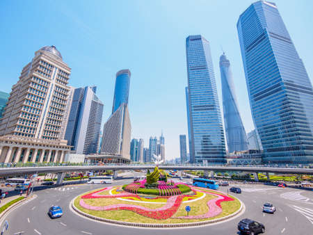 city and grass with blue sky, the modern building of the lujiazui financial center in shanghai chinaのeditorial素材