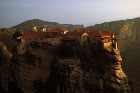Single monastery on the rock in Greece at sunsetのeditorial素材