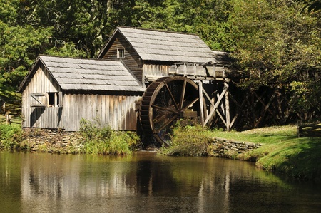 A wooden water mill with a lakeのeditorial素材