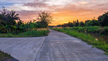 Concrete canal ran straight toward the sun at sunriseの写真素材