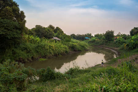 Two people is fishing near the river, Lopburi River, Singburi, Thailand.の写真素材