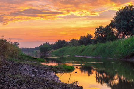 Beautiful sunrise reflection in a canalの写真素材