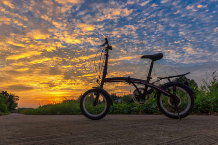 Bike Silhouette on a field with beautiful sunsetの写真素材