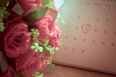 Calendar page with a red hand written heart highlight on February 14 of Saint Valentines day as a...