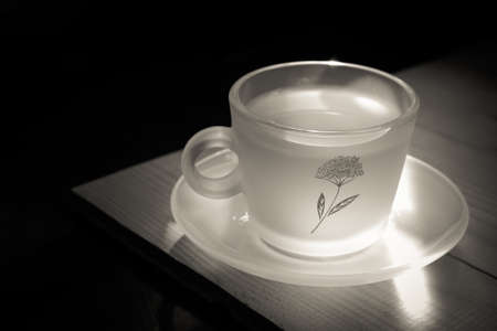 black and white picture cup of tea on vintage white woodの写真素材