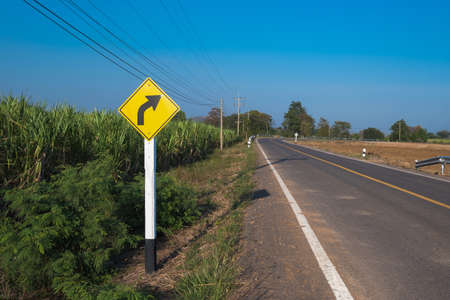 sunset in clouds with sunrays over road to horizonの写真素材