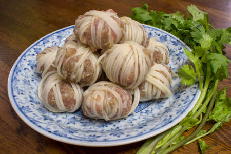 Mhoo sarong  (Deep fried wrapped pork ball with noodle) menu is Thai food. Made from grated pork wrapped in vermicelli. This image was taken before frying.の写真素材