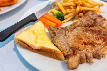 1 piece of fried meat with vegetables french fries and salad on a white background plate