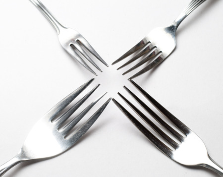Silver fork on white background の写真素材