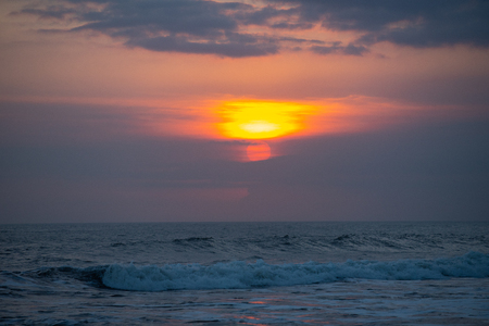 beautiful sunset over the sea wave ,in Bali Indonesiaの写真素材