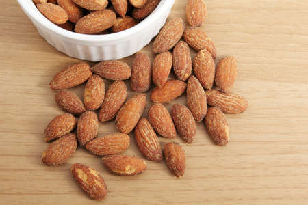 Roasted almonds with salt on wood backgroundの写真素材