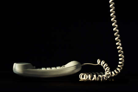 Telephone with cord isolated on blackの写真素材