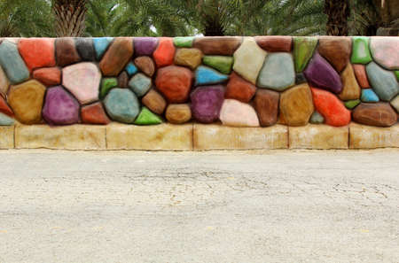 Colorful stone wall background on concrete streetの写真素材