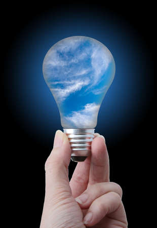 Clean air concept  Lightbulb with sky and white cloud insideの写真素材