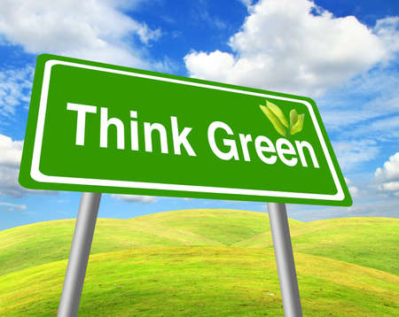 Think green sign over grass field and blue skyの写真素材