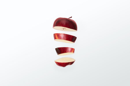 Red apple slices on white background. Isolated with clipping path.