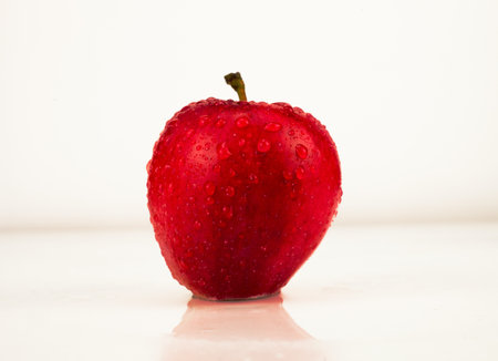 Red apple with water drops isolated on white background. Studio shot.の写真素材