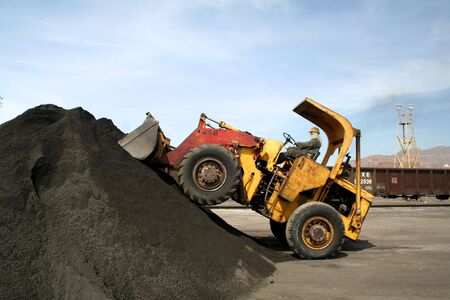 Front loader stacking up a pile of copper ore.