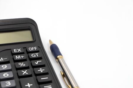 Calculator and pen isolated on white background. The machine is made of plastic. There is a numeric keypad. Used to calculate mathematics or financial accounting. And use a pen to take notesの写真素材