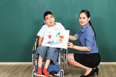 A group of young girls with disabilities and autism is training their hand and finger muscles by...