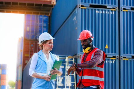 A team of African American men and Caucasian women wear helmets. Work on controlling the loading of...