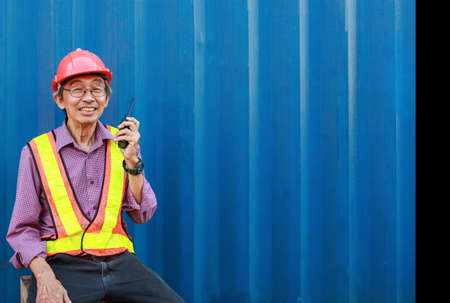 senior engineer or foreman check control Warehouse at container yard for international shipping business Moving industrial goods, logistics, import-export commercial transportの写真素材