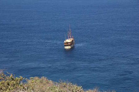 White ship with two masts in bright blue sea near bank of Bali.の写真素材