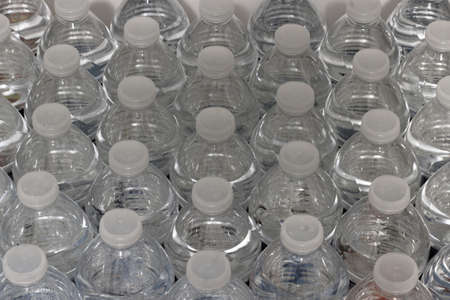 Fresh and pure natural water bottled into half liter bottles in a close up photography