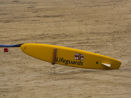August 18th, 2016:- a RNLI Lifeguard Rescue Board sits ready to be deployed on East Strand Portrush, Northern Irelandのeditorial素材