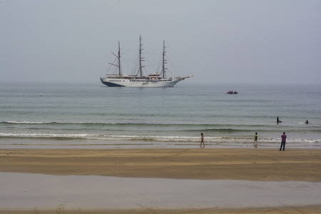 Cruise ship Sea Cloud II docked in the West bay Portrush, Northern Ireland on a misty summer afternoon on August 18th 2016. There are also some unknown persons in the foreground.のeditorial素材