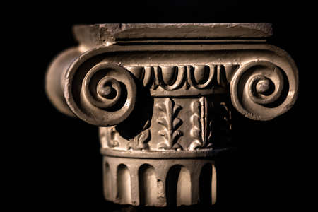 Dummy of an ancient Greek column isolated in black background.