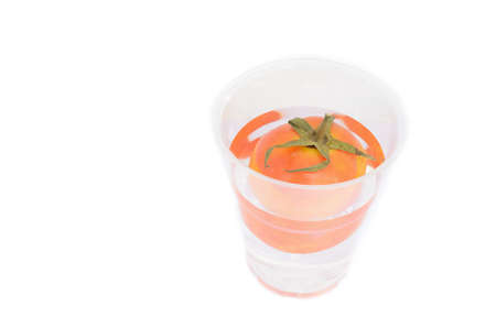  Tomato in water glass isolated on whiteの写真素材