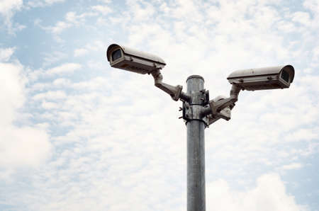Security cameras against blue skyの写真素材