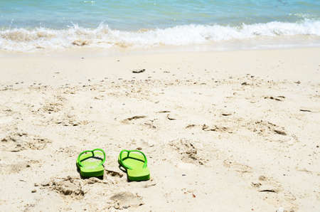 Flipflop sandals on sea beachの写真素材