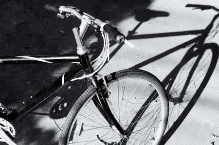 Black and white a bicycle against shadowの写真素材