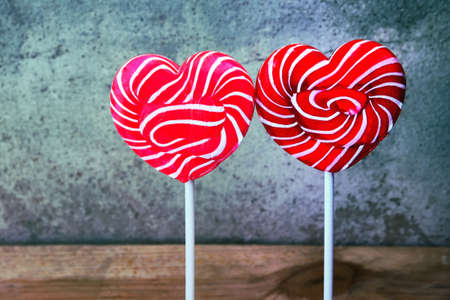 Heartshaped lollipops with old cement backgroundの写真素材