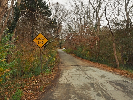 a stop sign on the side of a roadの写真素材