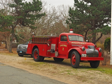 a red fire truck driving down the roadのeditorial素材