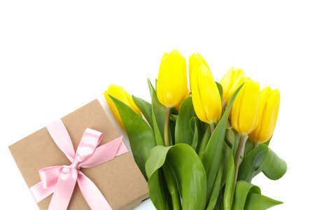 Beautiful bouquet of yellow tulips with gift isolated on white background
