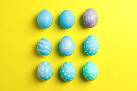 Flat lay composition with colorful easter eggs on yellow background. Top viewの写真素材
