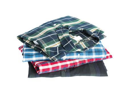 Stack of colorful shirts isolated on white backgroundの写真素材